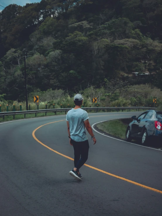 a man riding a skateboard down the middle of a road