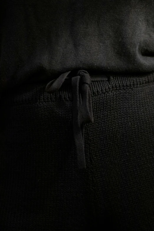 the side view of a man's pants with a tie