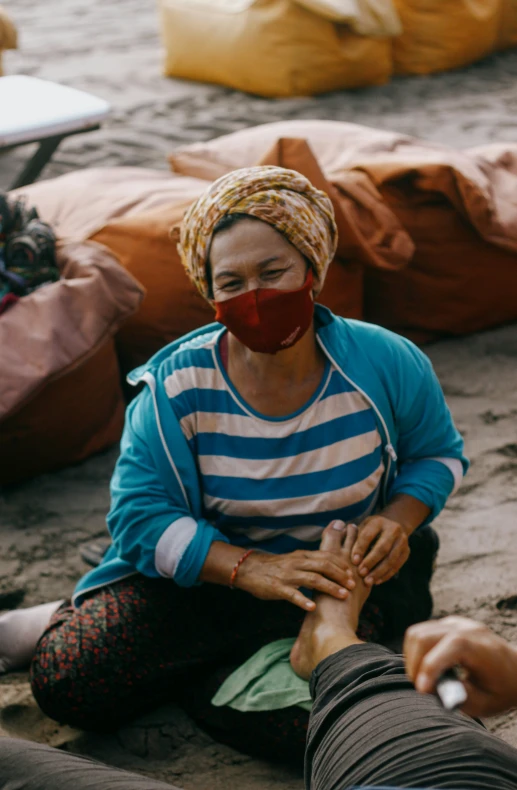 a woman with a surgical mask holds hands together