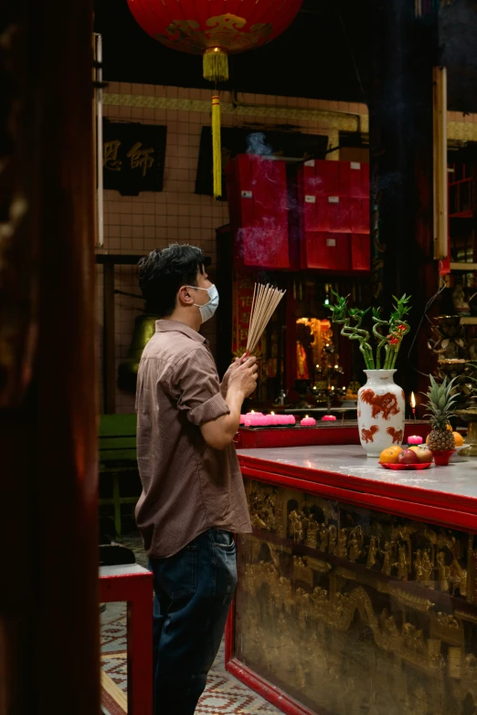 a man putting incenses on his hands