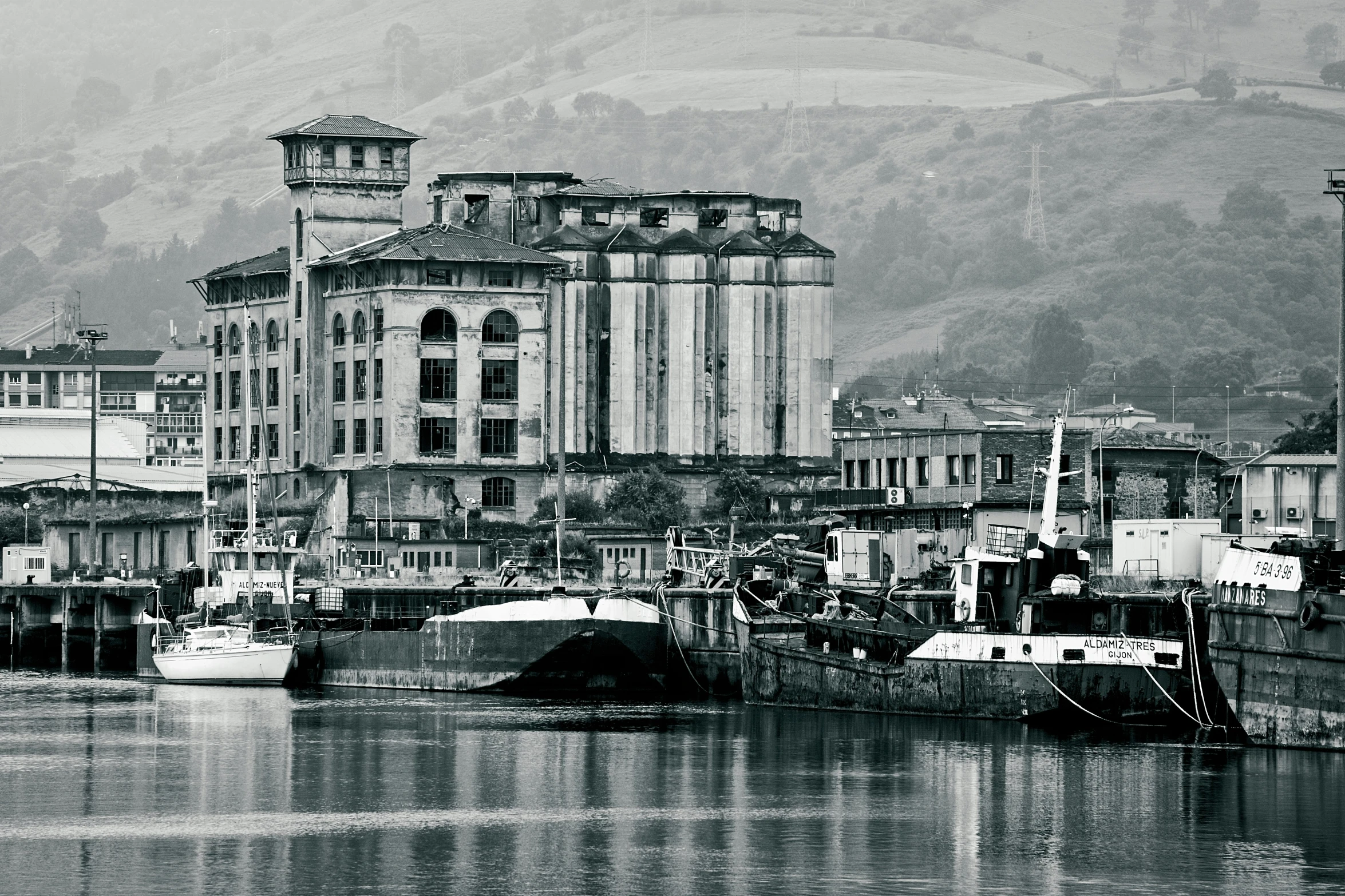 black and white image of the harbor with various ships