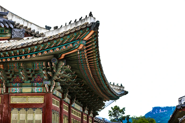 this is an oriental building with a roof and a clock on the side