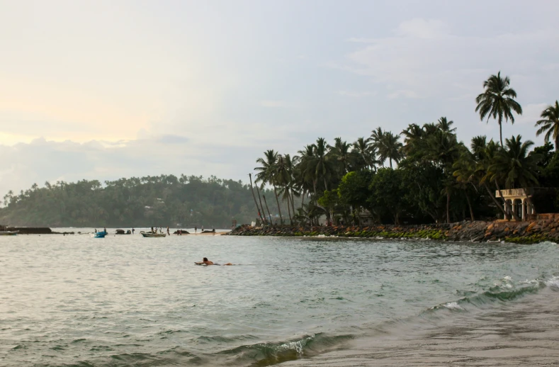 some people riding boats on a body of water