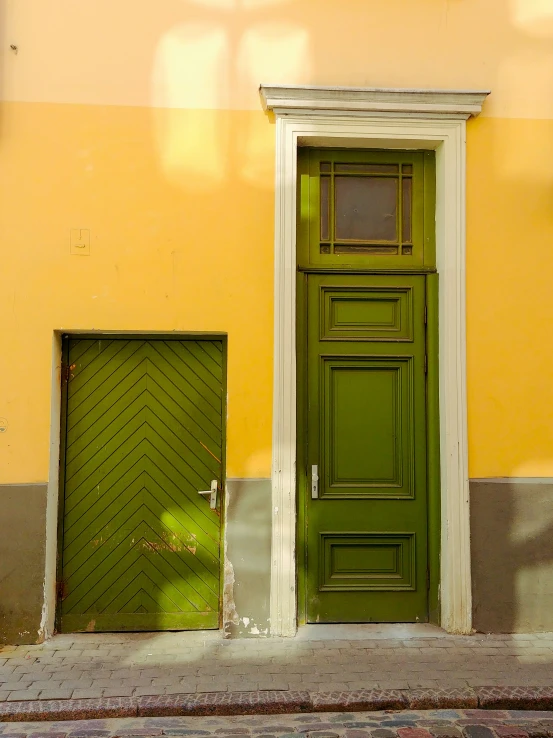 a door to the side of a yellow building