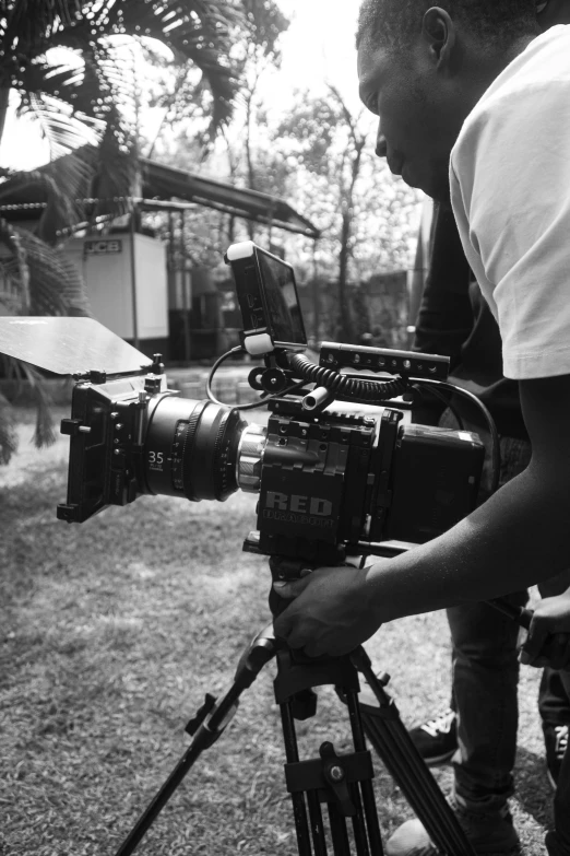 a man holding a camera next to some other people