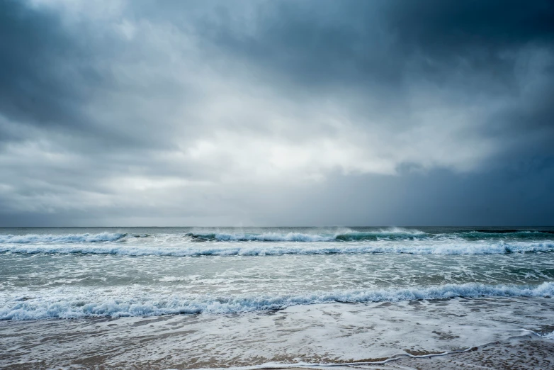 an ocean beach covered in lots of waves