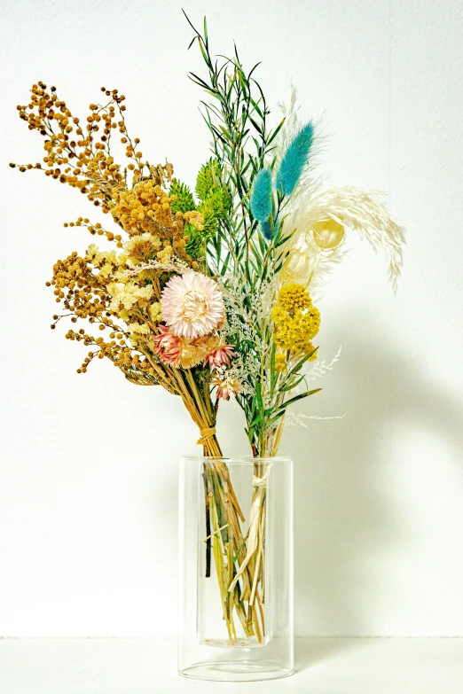 there is a flower bouquet in a clear vase