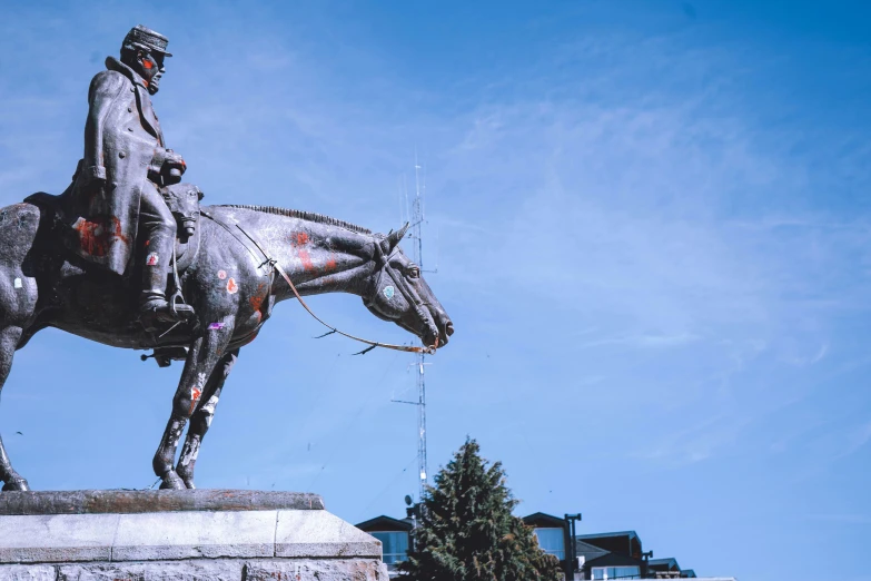 a statue of a man on a horse in the street