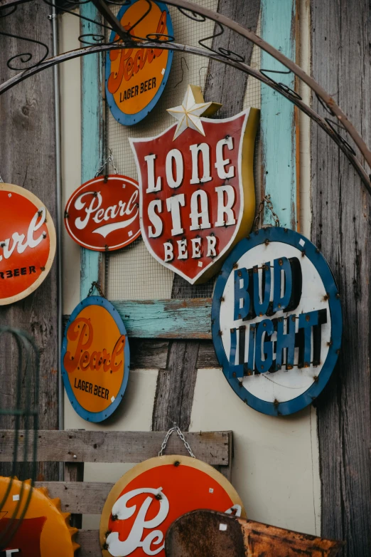 a bunch of neon signs hanging on the side of a building