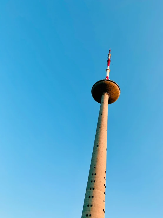 a tall tower with a flag on top of it