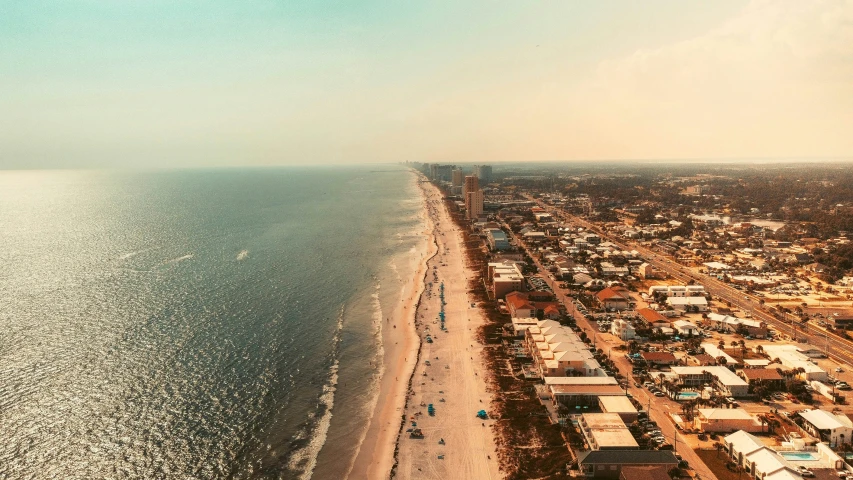 this aerial view shows the city, beach, and ocean from a kite