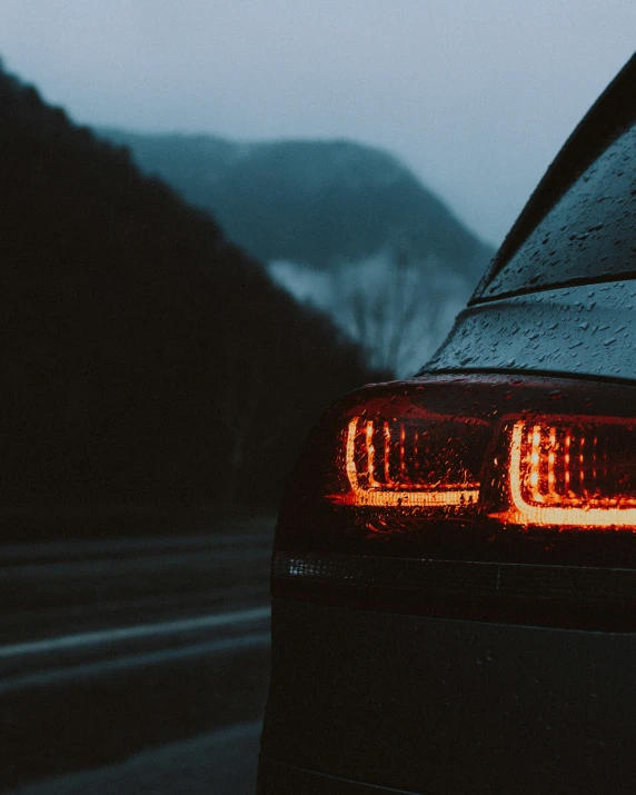 the headlights of a car on a rainy day