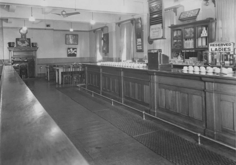 an old po of a bar with several bottles and bottles