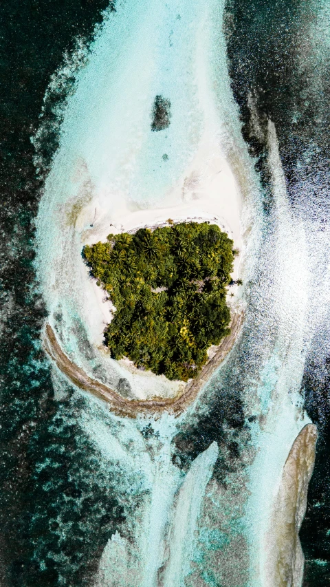 an aerial view of the island in the middle of the ocean