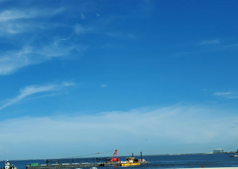 some fishing boats and the ocean and a sky