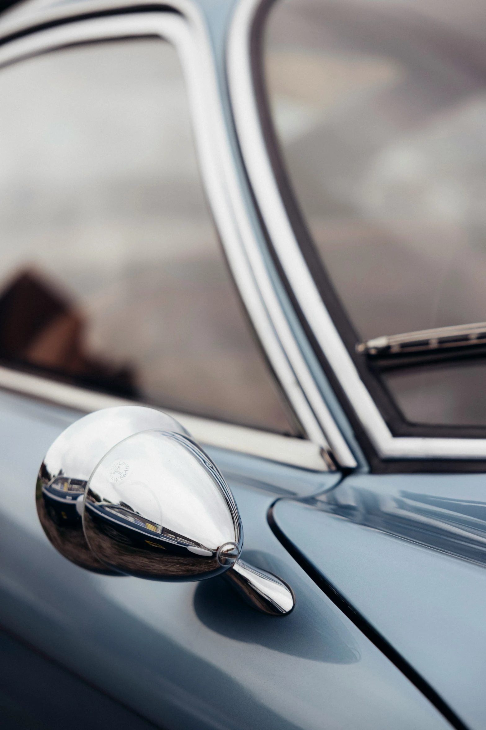 the reflection of a woman in a car mirror