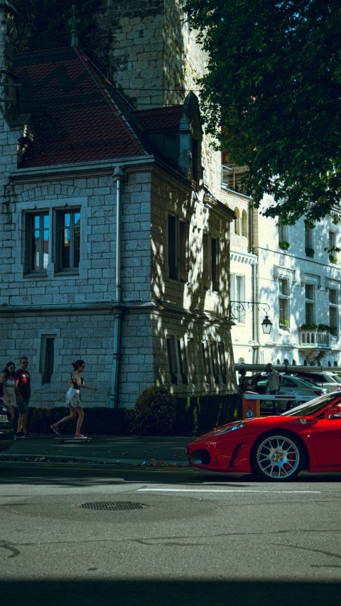 a red sports car is parked along the side of the road