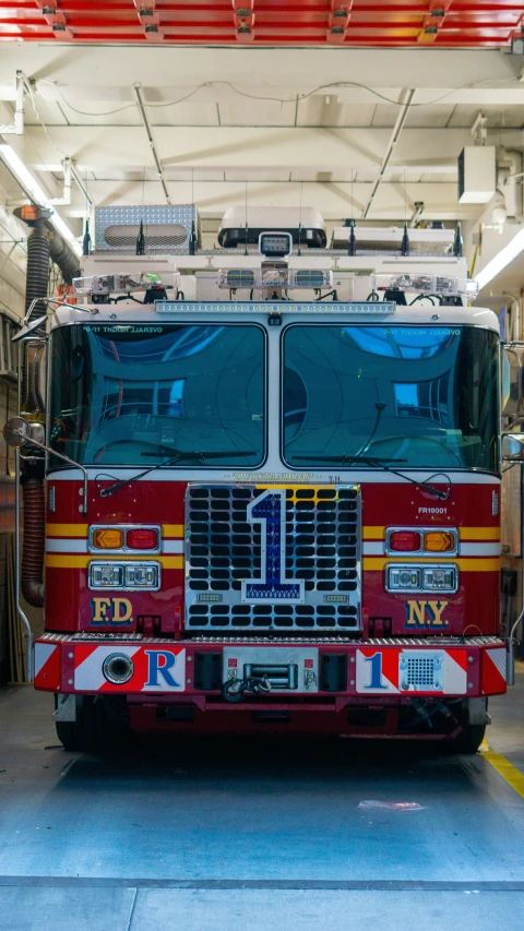 a red fire engine parked inside of a garage