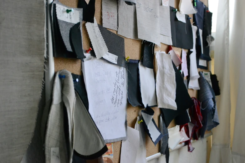 several pieces of clothing are hung on a wall