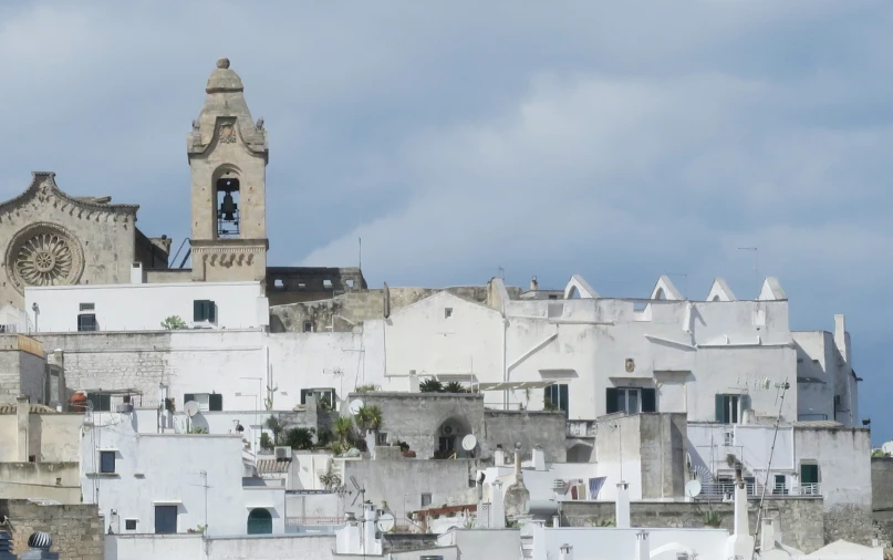 a clock tower is on top of a very white city