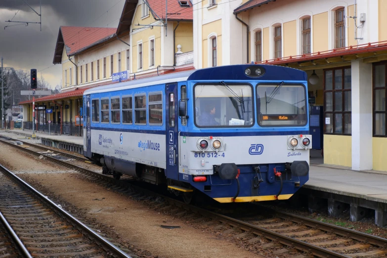 a train traveling down tracks next to a building