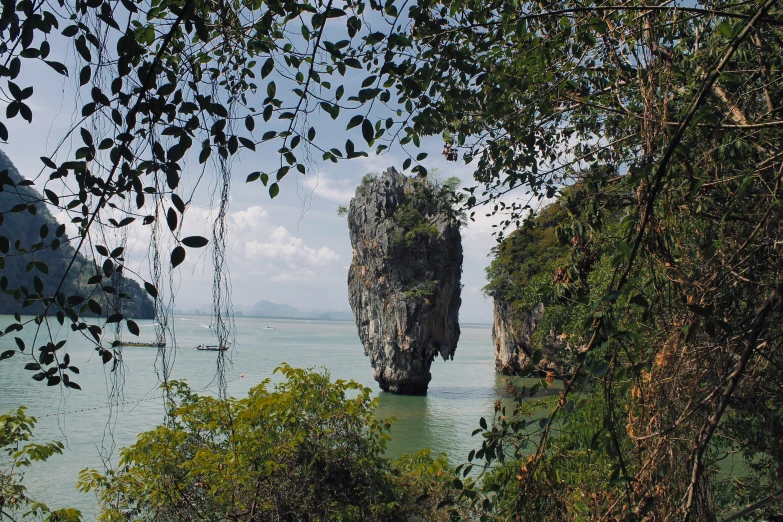 a rock outcropping in the water on a beach