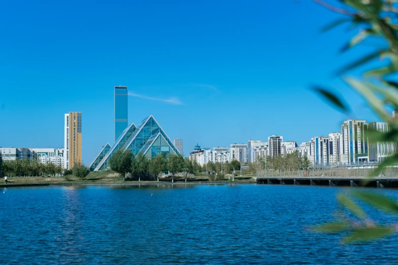 the city skyline and the water have a very tall building