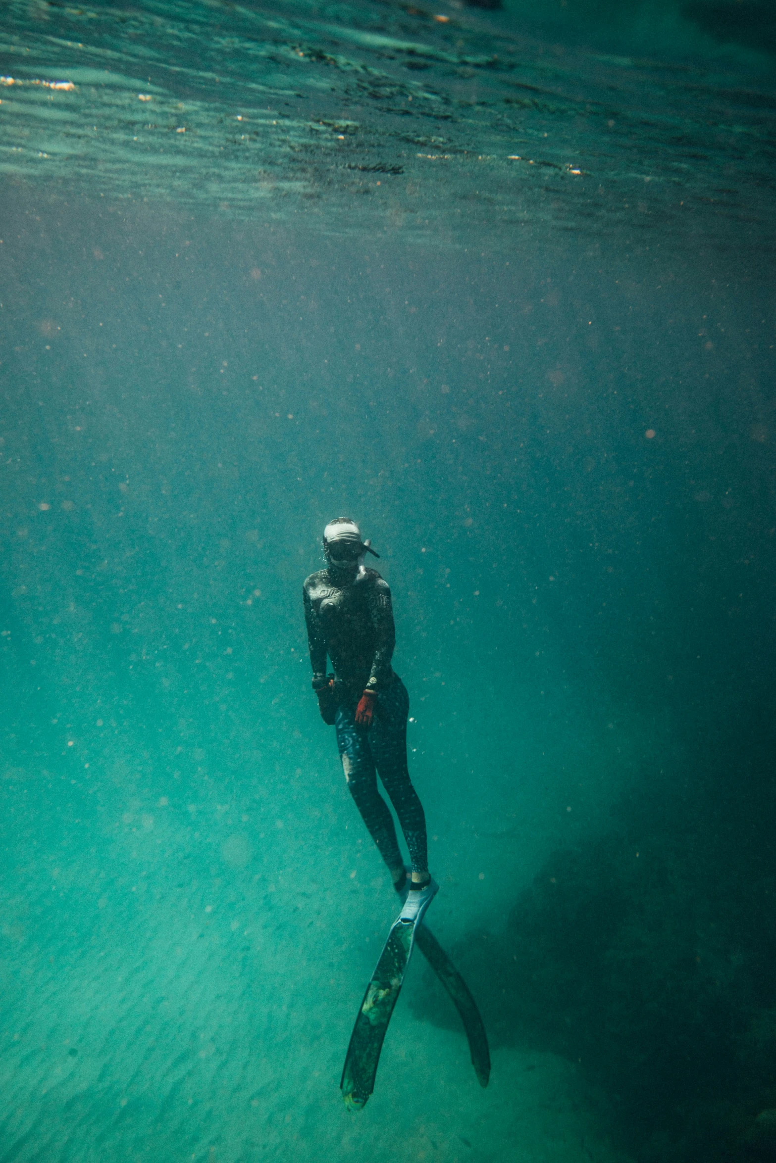 a man is underwater in the blue sea