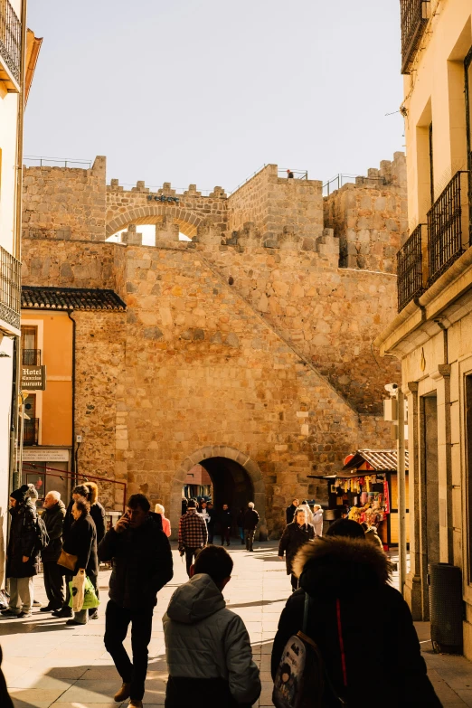 a group of people on a path near a castle