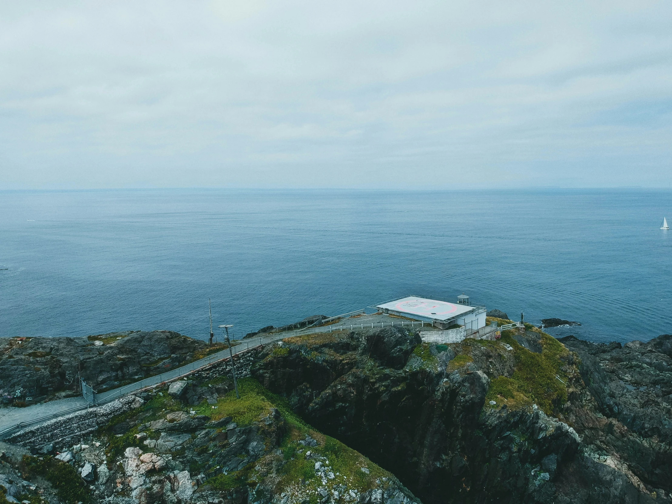 a bird's eye view of a road going down to the ocean