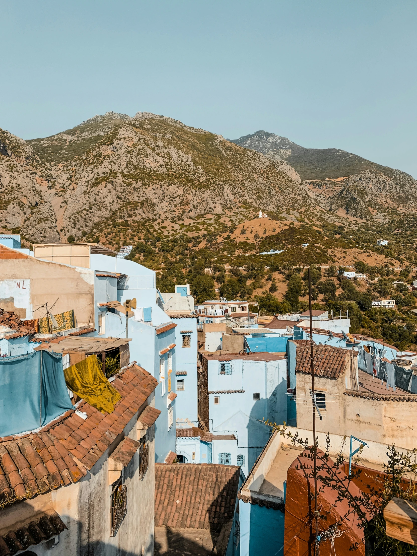 a view of some buildings in the mountains