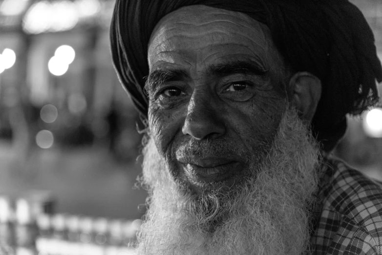 an old man with a turban and a long beard
