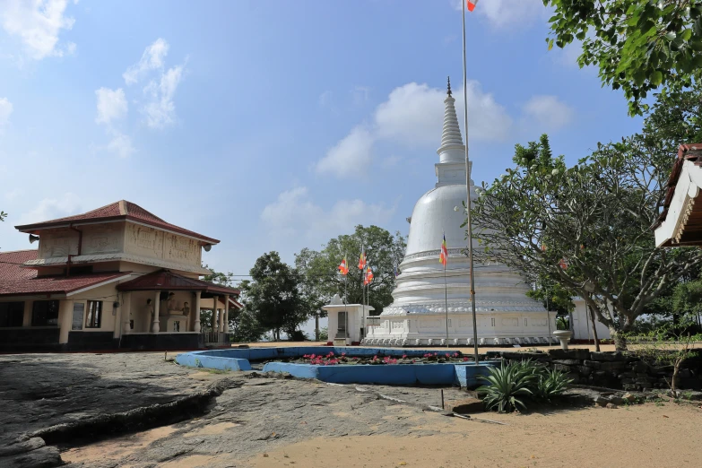 there is a tall white temple with a flag at the top