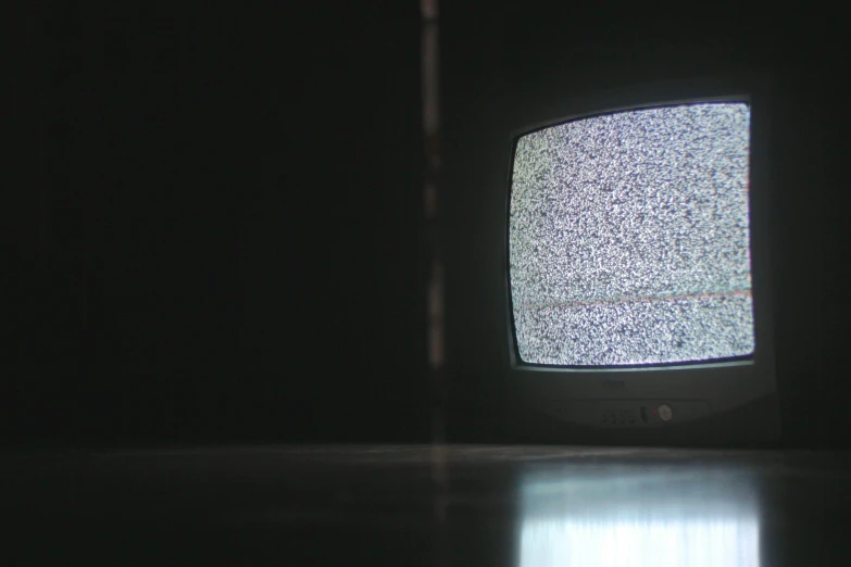 an old fashioned tv set sitting in the dark
