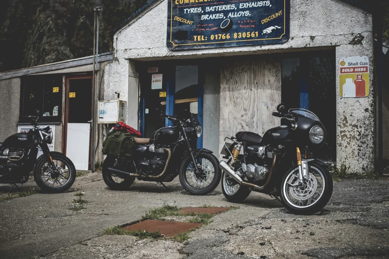 a few motorcycles are parked in front of a store