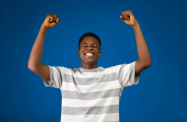 a woman smiles in victory and flex her fists