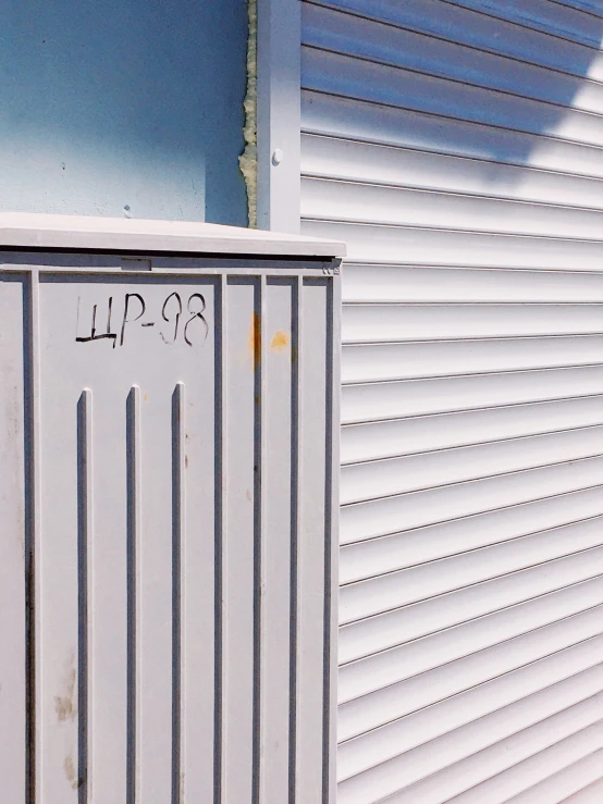 white metal door sitting outside a house on the side