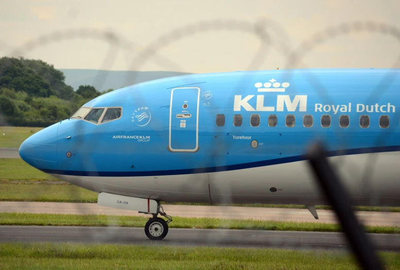 a large plane is parked by the runway