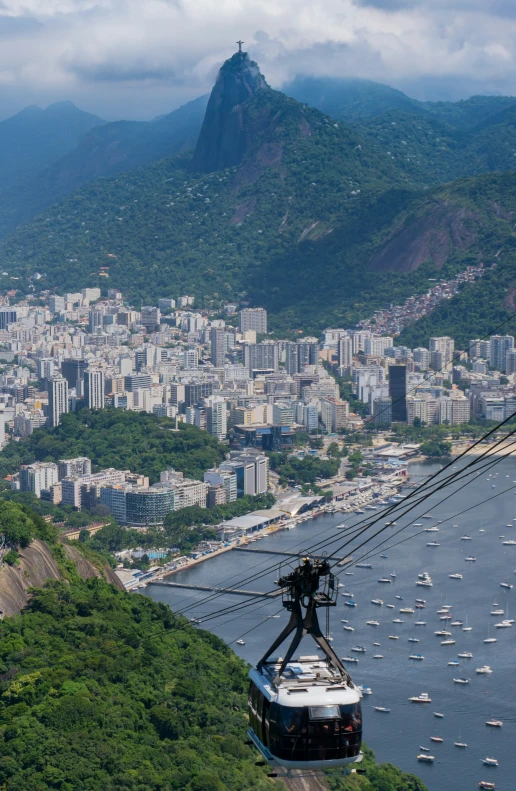 a cable car overlooking a city with boats on it