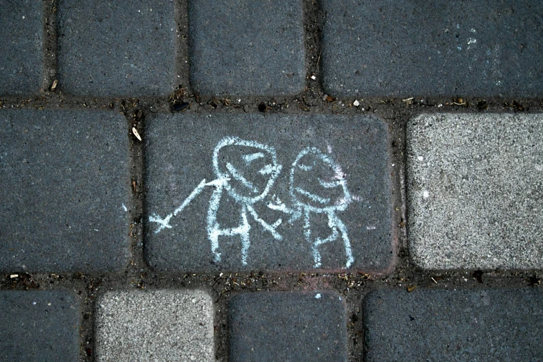 the image of a stick figure on an asphalt area