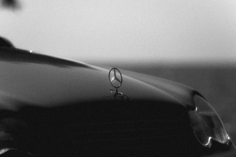 the hood ornament of a car is seen in black and white