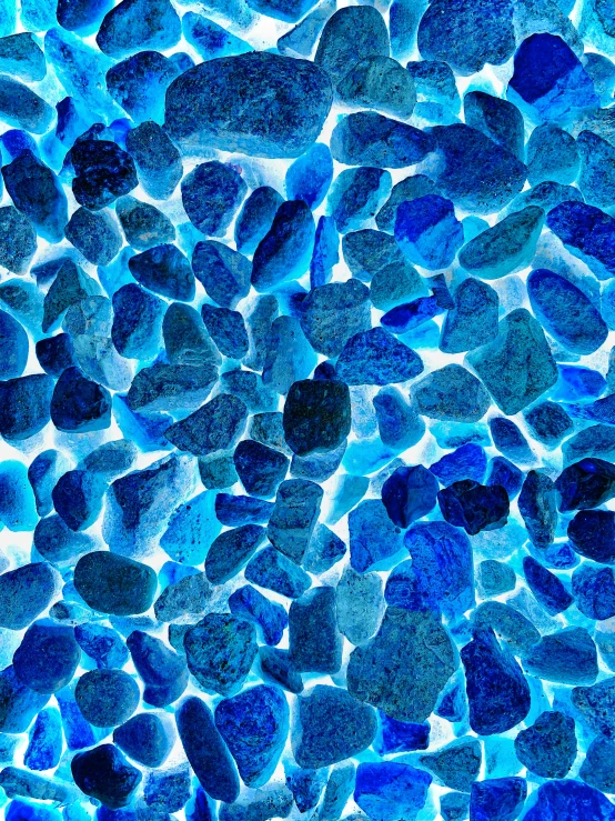 an abstract pograph of blue rocks on a glass surface