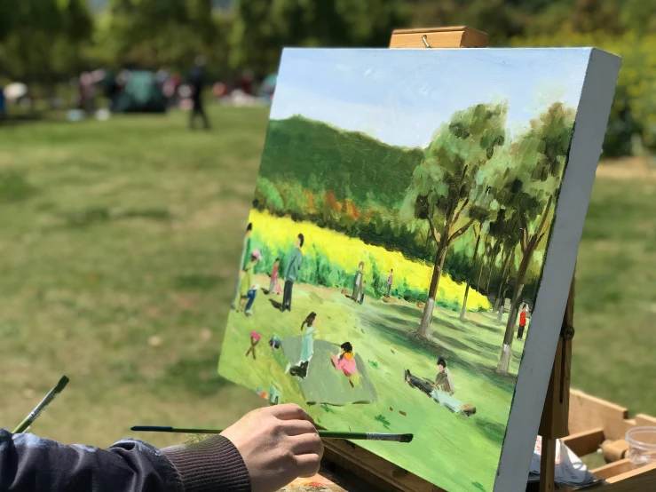 a person painting in front of trees with others on it