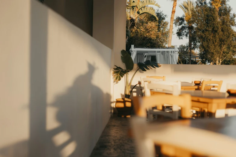 a person standing next to tables and chairs