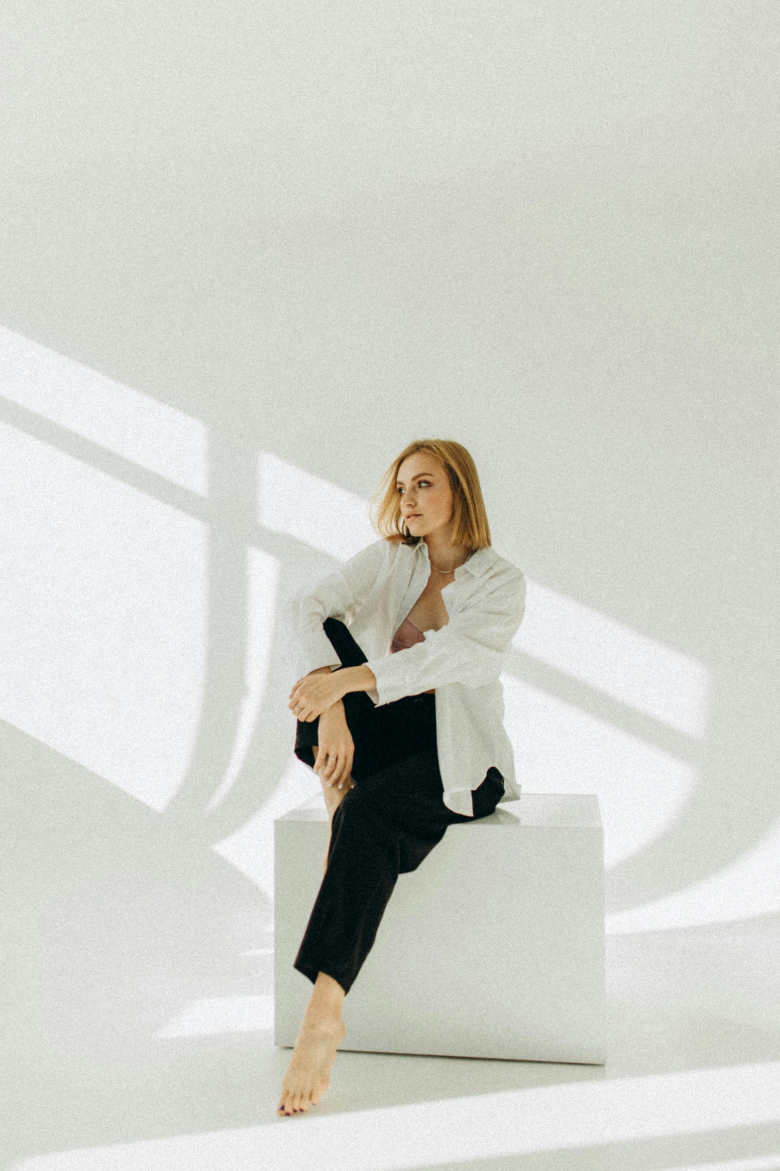 woman in black pants and white shirt sitting down