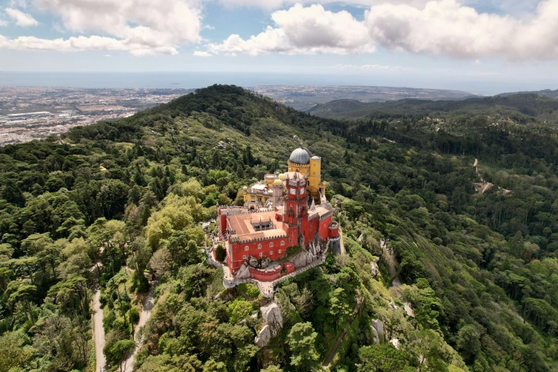 a scenic view of a castle like building on top of a mountain