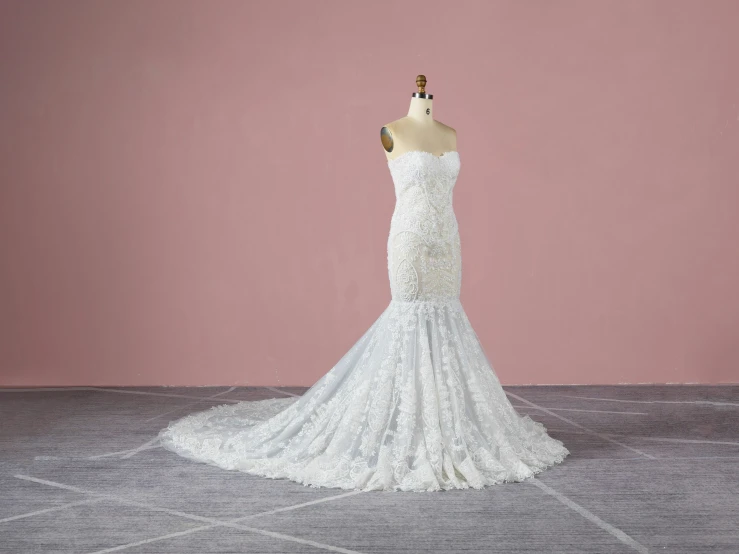 a mannequin wearing a wedding dress on a pedestal