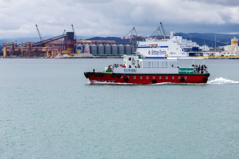 a large red and white boat moving through the water