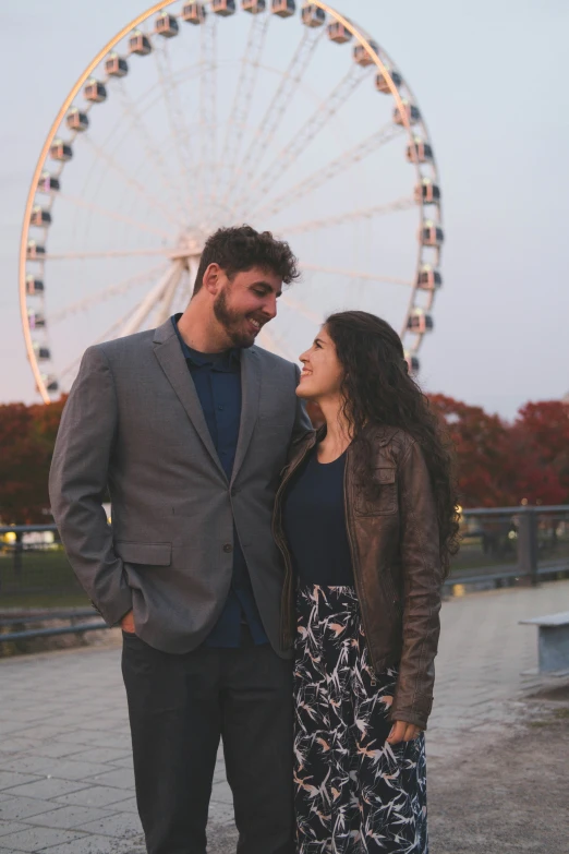 a couple looking into each other eyes at a ferris wheel