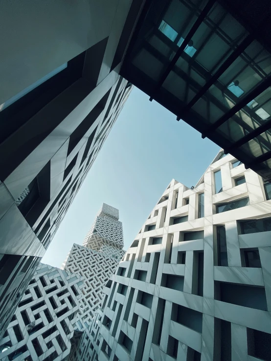 some buildings with glass windows and a building behind them